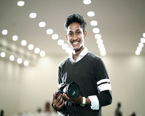 Portrait of a young professional smiling naturally in a well-lit indoor space